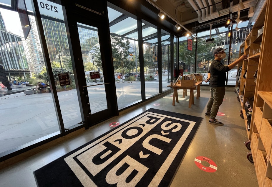 Caption: A customer is browsing Subpop's pop-up store on Amazon's campus