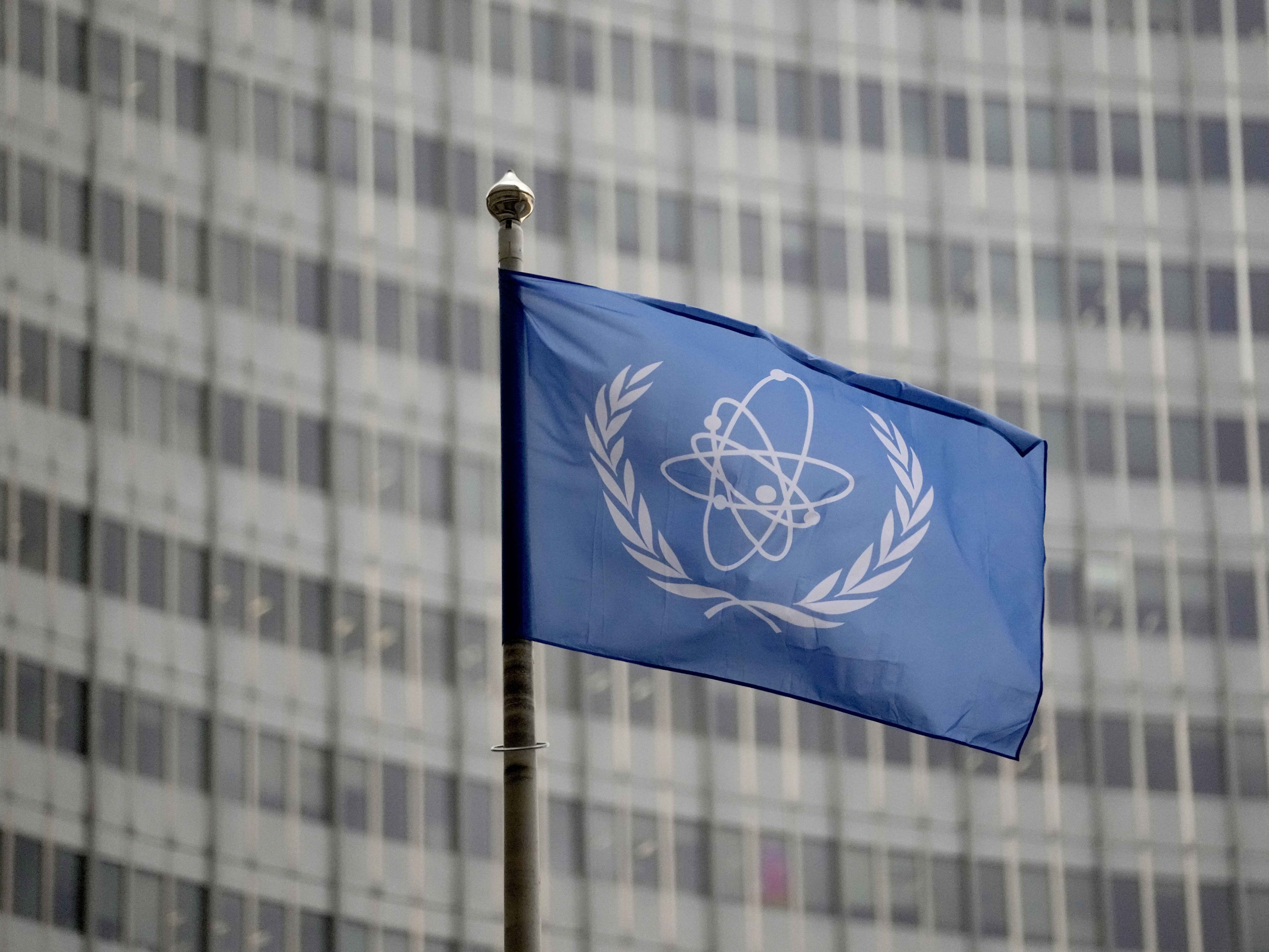 caption: The flag of the International Atomic Energy Agency flies in front of its headquarters during an IAEA Board of Governors meeting in Vienna, Austria.