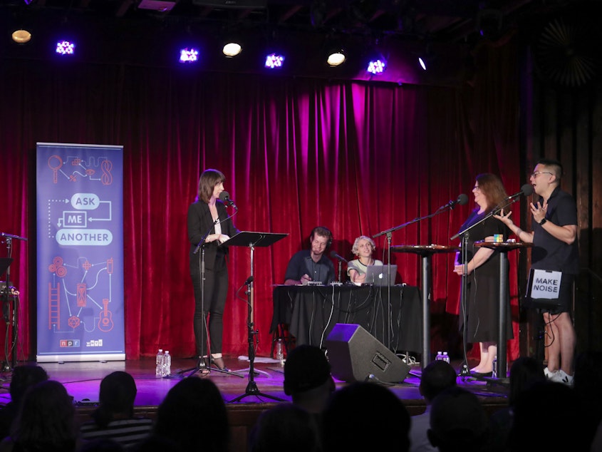 caption: Contestants and comedian Bowen Yang compete in <em>Ask Me Another's</em> final round at the Bell House in Brooklyn, New York.