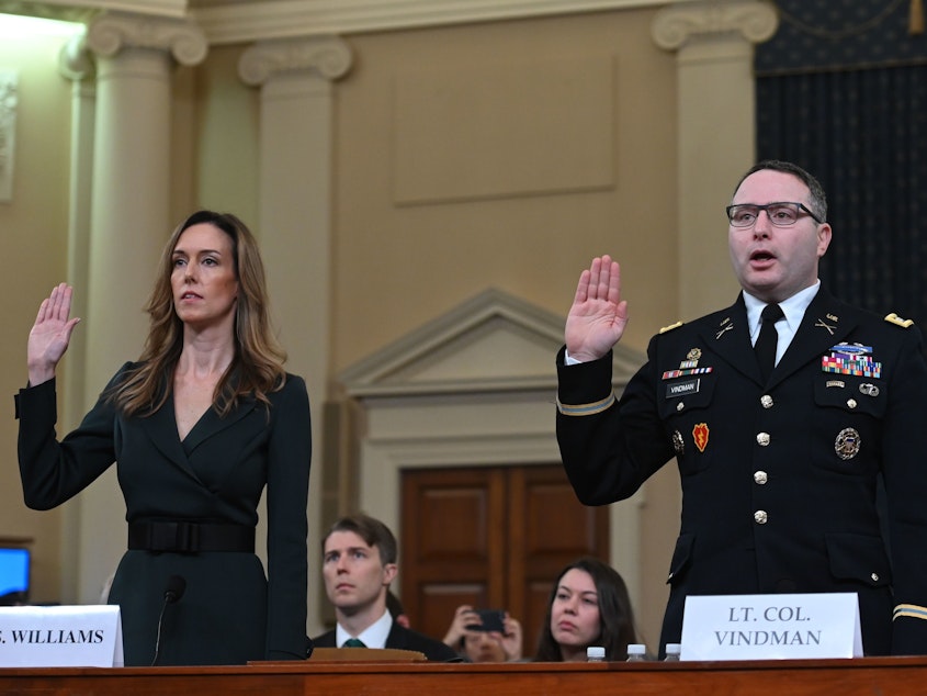 caption: Jennifer Williams and Lt. Col. Alexander Vindman take the oath before they testify during the House Intelligence Committee hearing on Tuesday.