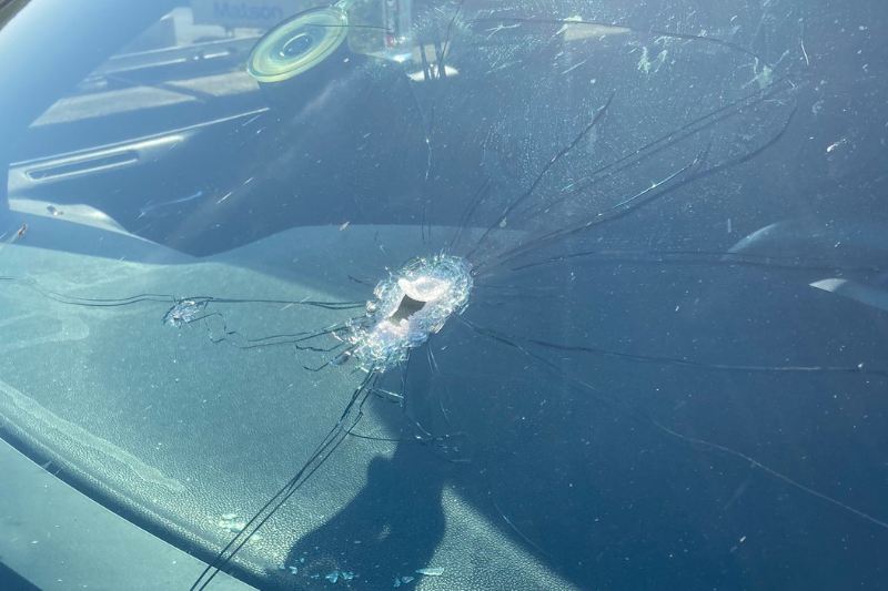 caption: A bullet hole in the windshield of Dodge Charger. The Charger had four children inside when it got caught in a freeway shootout between two other cars. The hole in the windshield is not from the two other cars, however. It is from the driver who fired back at them. 