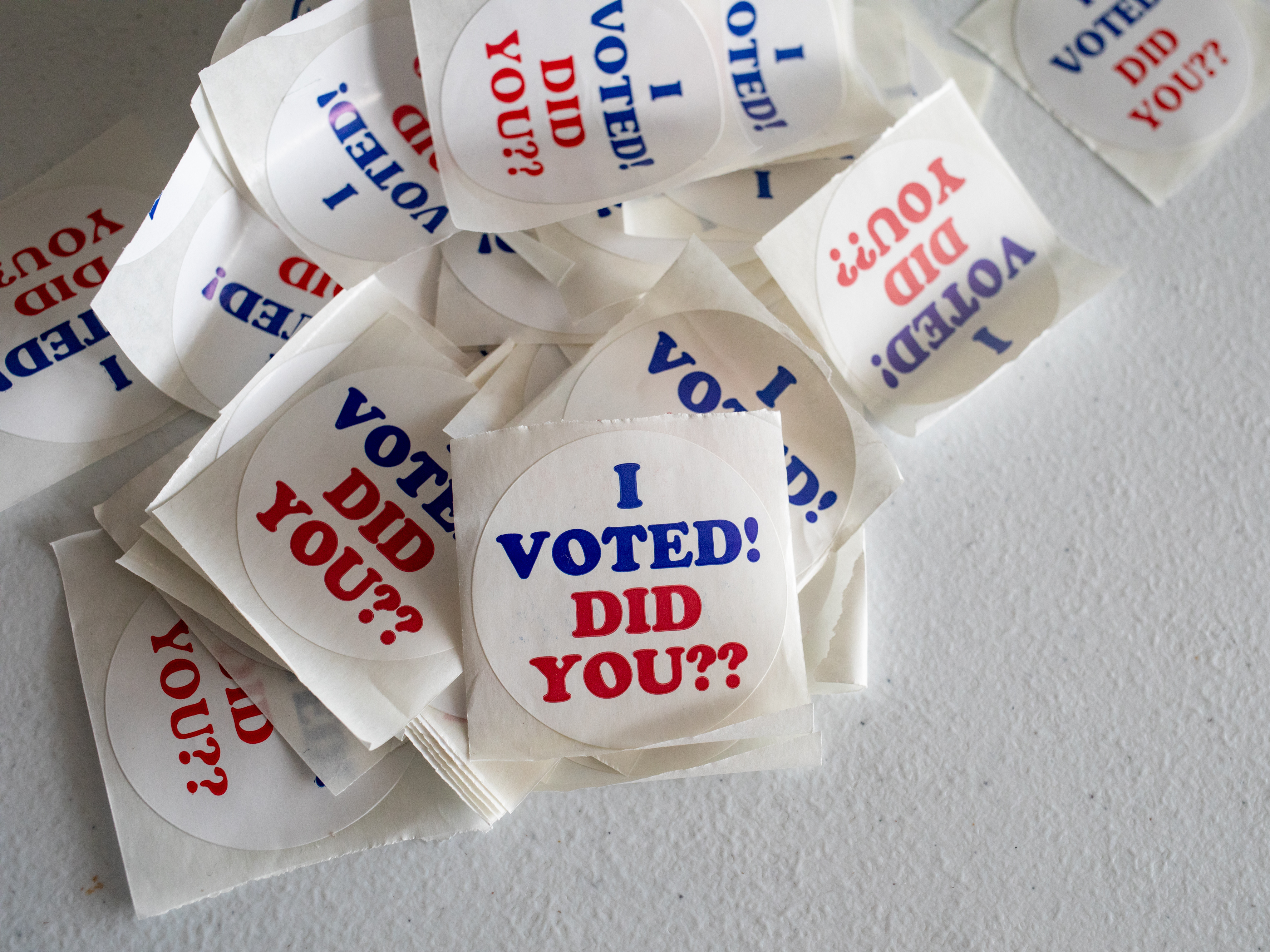 caption: "I Voted" stickers on a table on the last day of early voting at a polling station inside Wayne County Community College Northwest Campus in Detroit on Feb. 25.