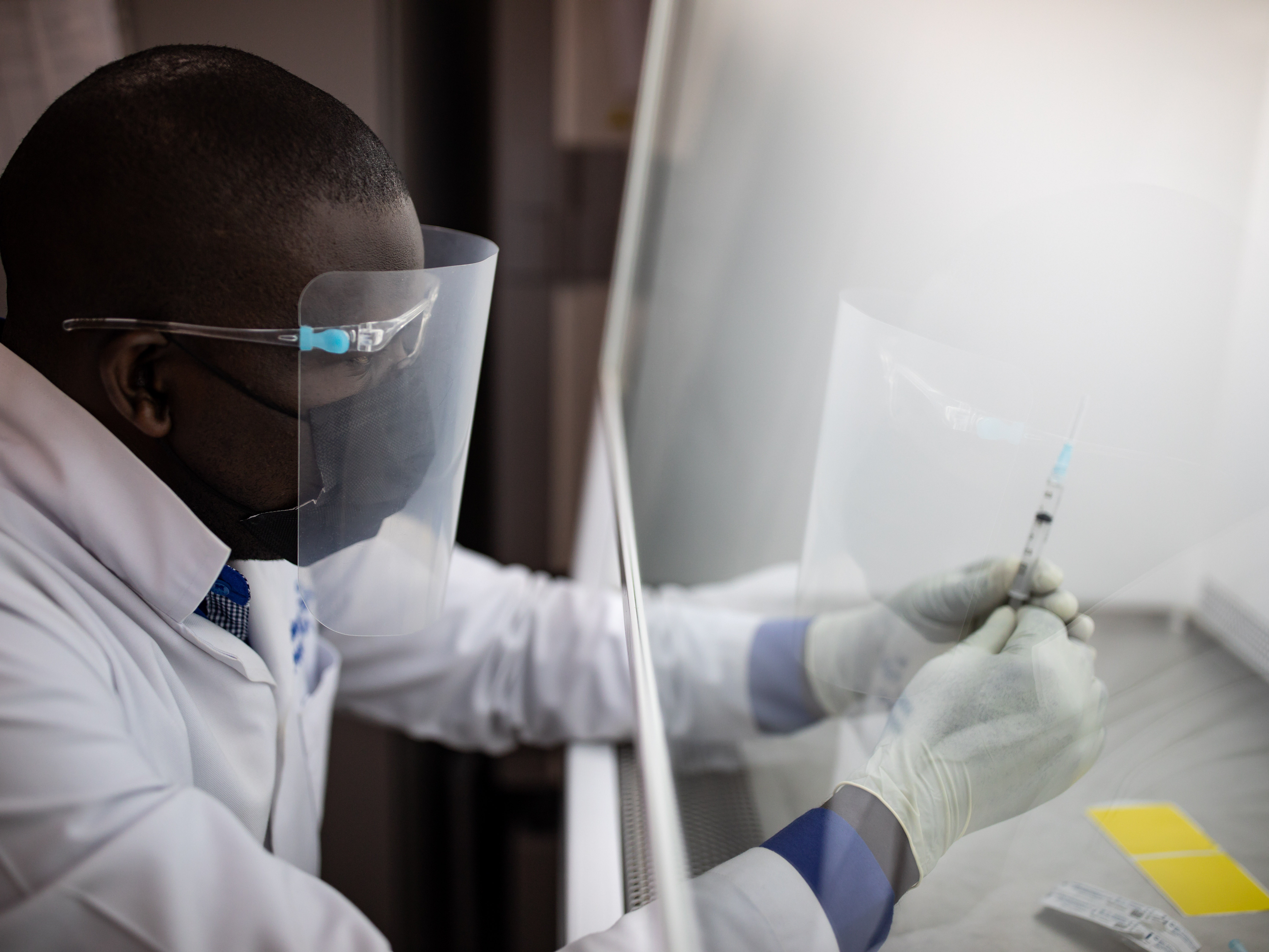 caption: A vaccine pharmacist prepares samples as part of an HIV vaccine trial on March 16, 2022 in Masaka, Uganda. The vaccine in that trial did not prove effective. A promising vaccine development program funded by the National Institutes of Health was just informed by the Trump administration that its support will end next year.