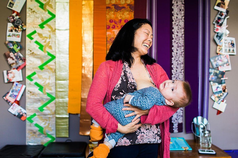 caption: Mari Hirabayashi with her son Ely, 9 months, at their home in Rainier Beach.