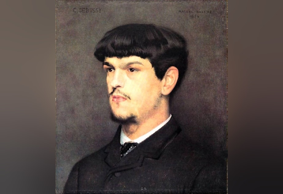 caption: A portrait of composer Claude Debussy painted by Marcel  Baschet, 1884.