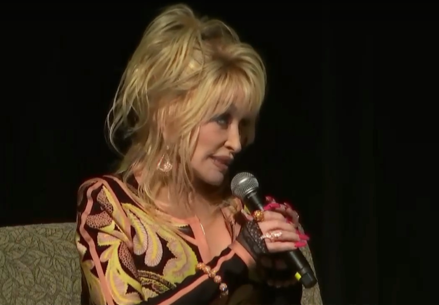 caption: Dolly Parton with Washington State Superintendent Chris Reykdal at Tacoma's Pantages Theater, Aug. 15, 2023. Parton was in Washington to celebrate her "Imagination Library" going statewide. The program provides free books to children up to the age of 5. 