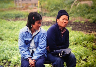 caption: Cheu Chang, right, at the Indochinese Farm Project in Woodinville in the mid-80s.