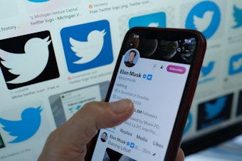 caption: This illustration photo taken in Los Angeles on April 20, 2023, shows Elon Musk's account on a smartphone. Under Musk as CEO, Twitter has changed how it labels accounts.