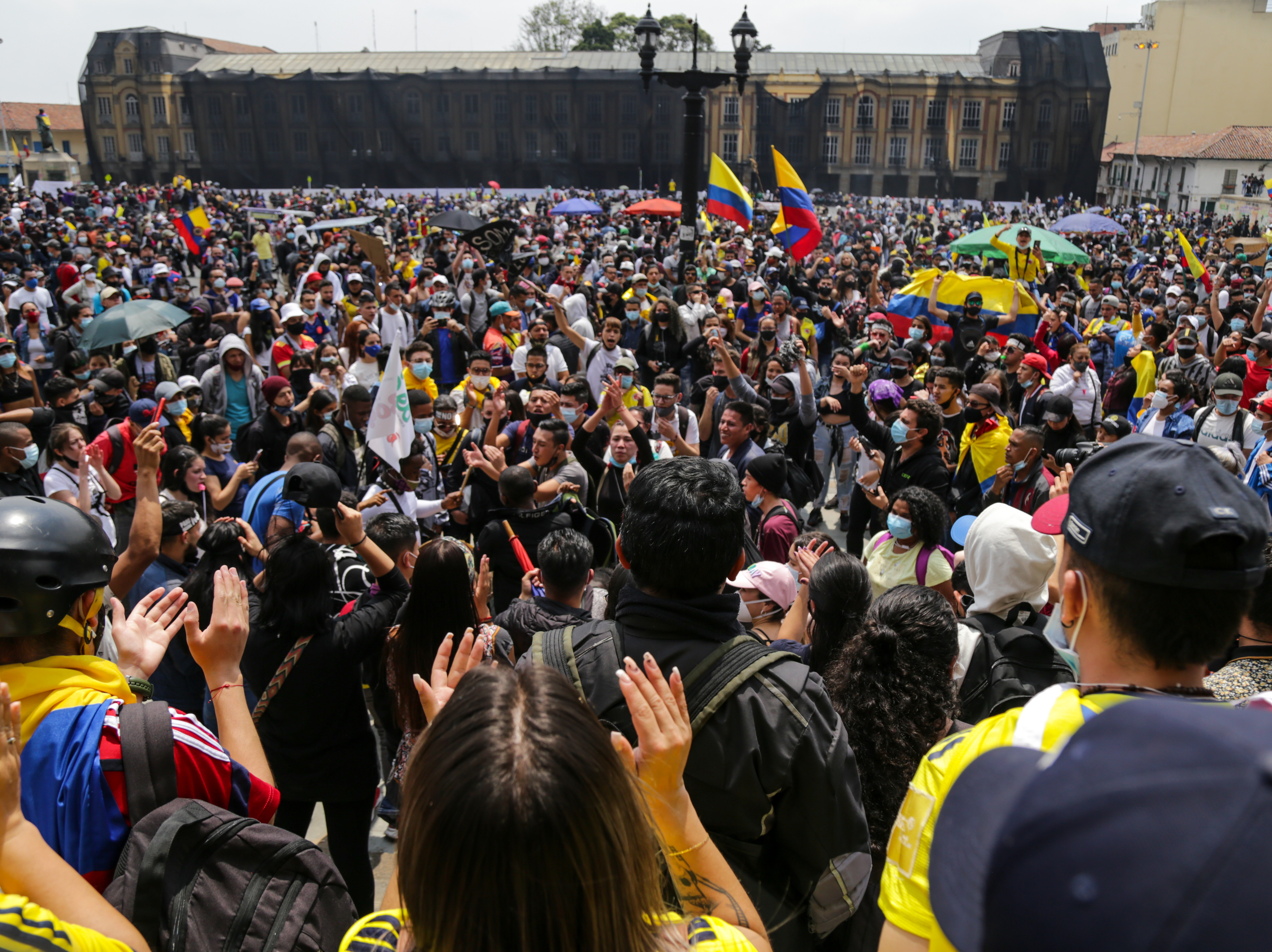 caption: Protesters attend a May Day rally against proposed tax changes in Bogota on Saturday.