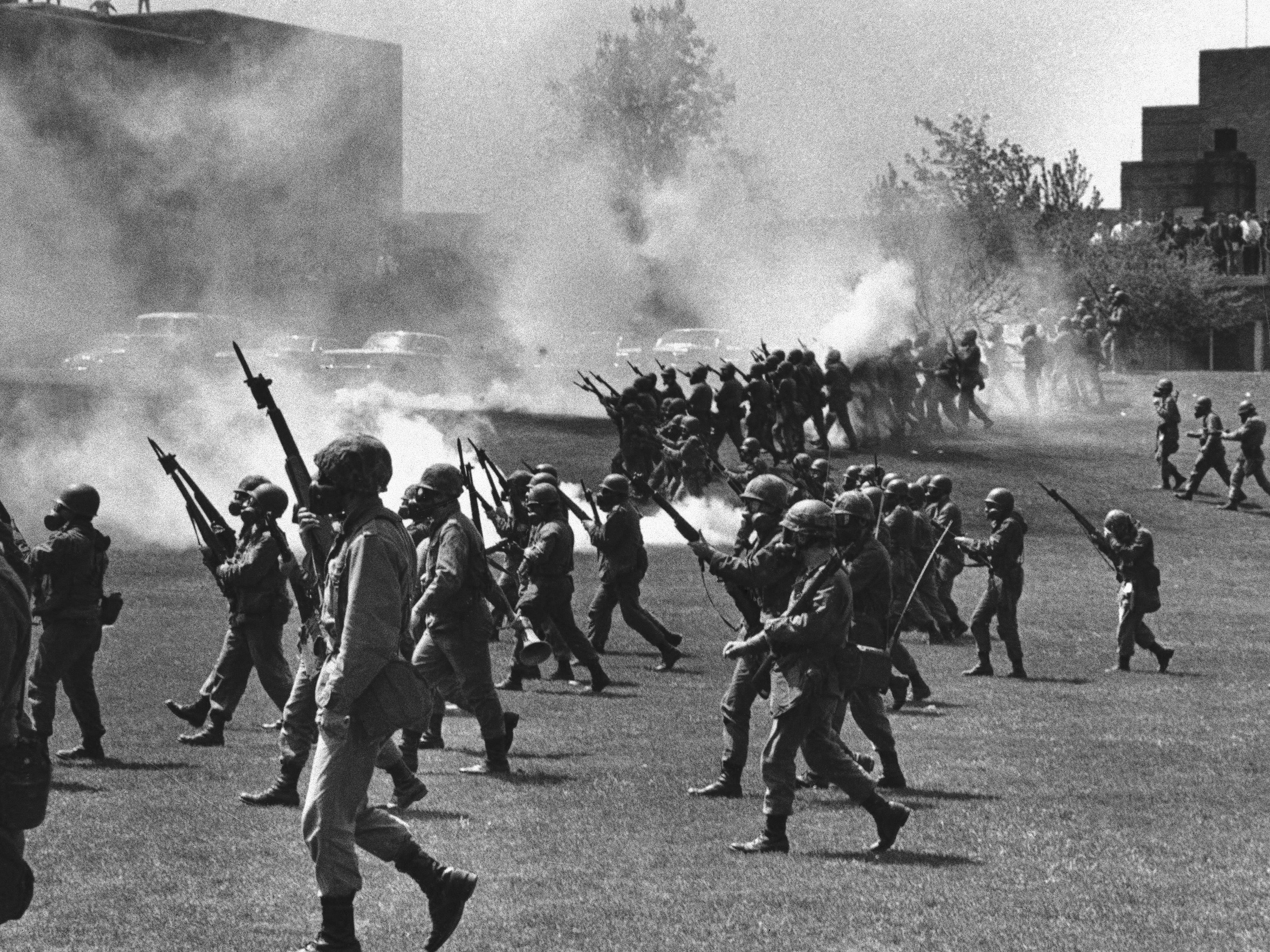 caption: Ohio National Guard members towards students at Kent State University in Kent, Ohio, on May 4, 1970. They fired into the crowd, killing four students and injuring nine.