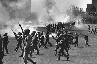 caption: Ohio National Guard members towards students at Kent State University in Kent, Ohio, on May 4, 1970. They fired into the crowd, killing four students and injuring nine.