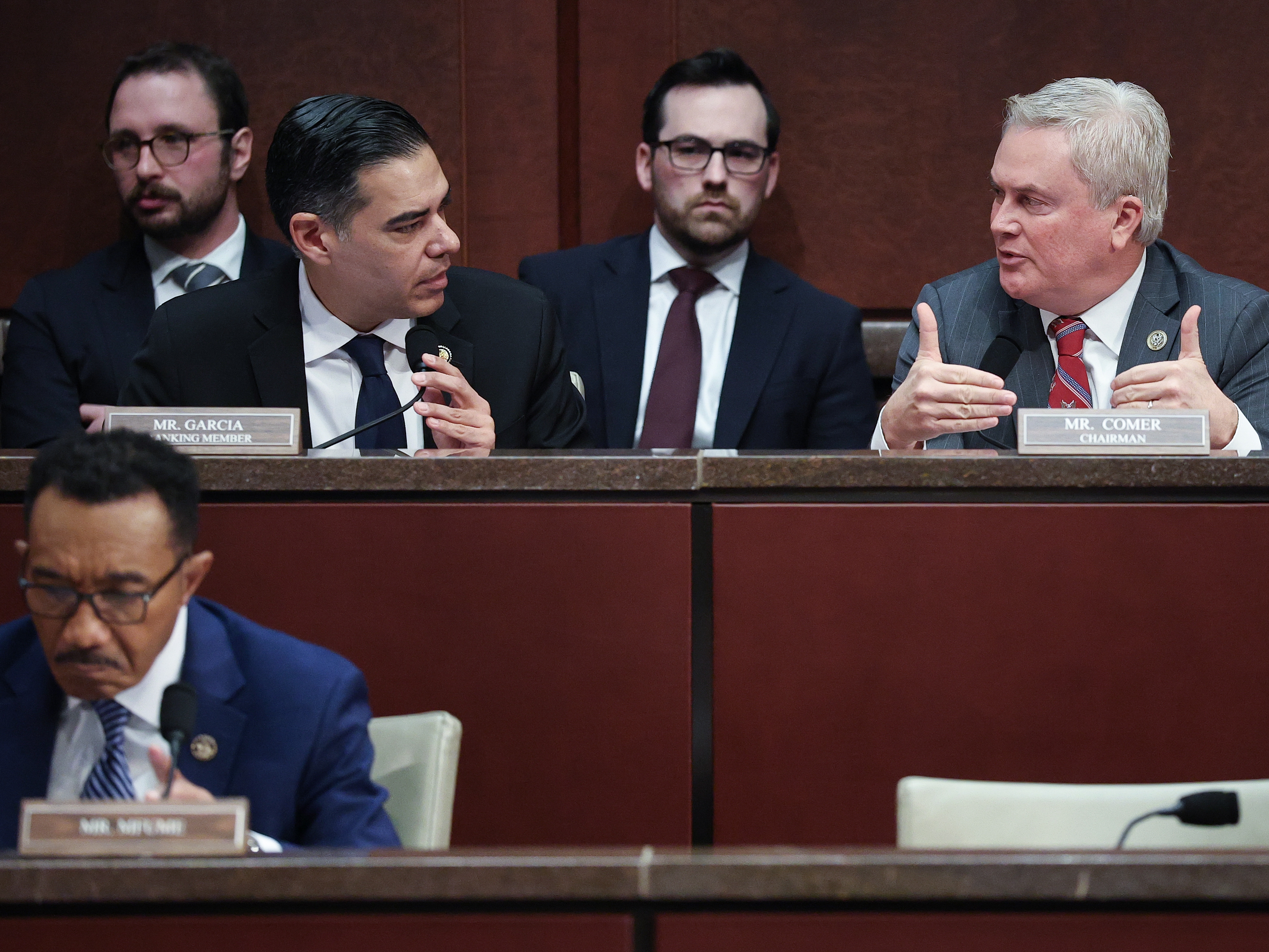 caption: House Oversight and Government Reform Committee chairman Rep. James Comer, R-Ky. (pictured right), and ranking member Rep. Robert Garcia, D-Calif., confer during a hearing Wednesday on whether to hold former President Bill Clinton and former Secretary of State Hillary Clinton in contempt of Congress.