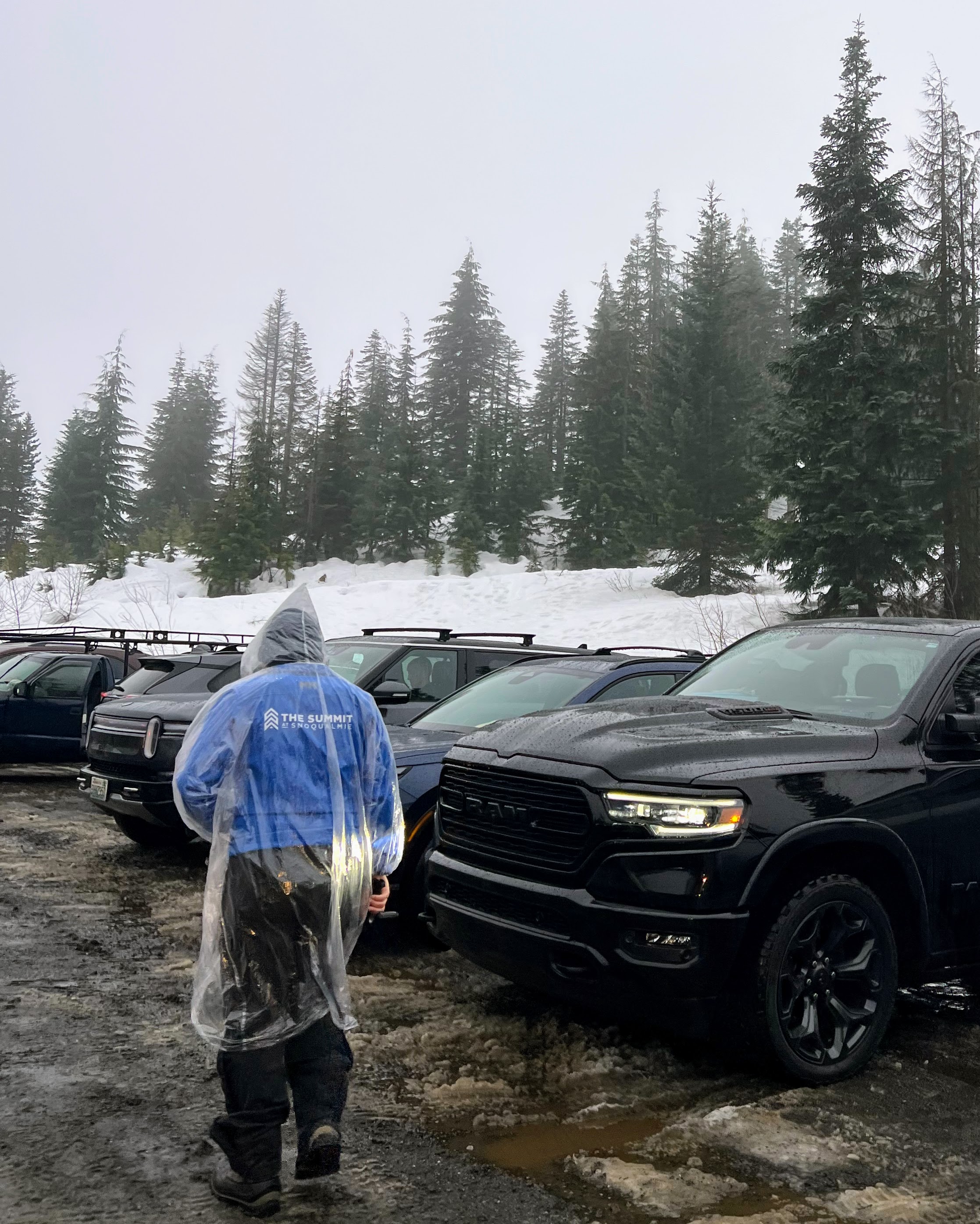 caption: A ski resort worker dons a rain parka on Jan. 31, 2026, at The Summit at Snoqualmie ski resort in Washington state. 