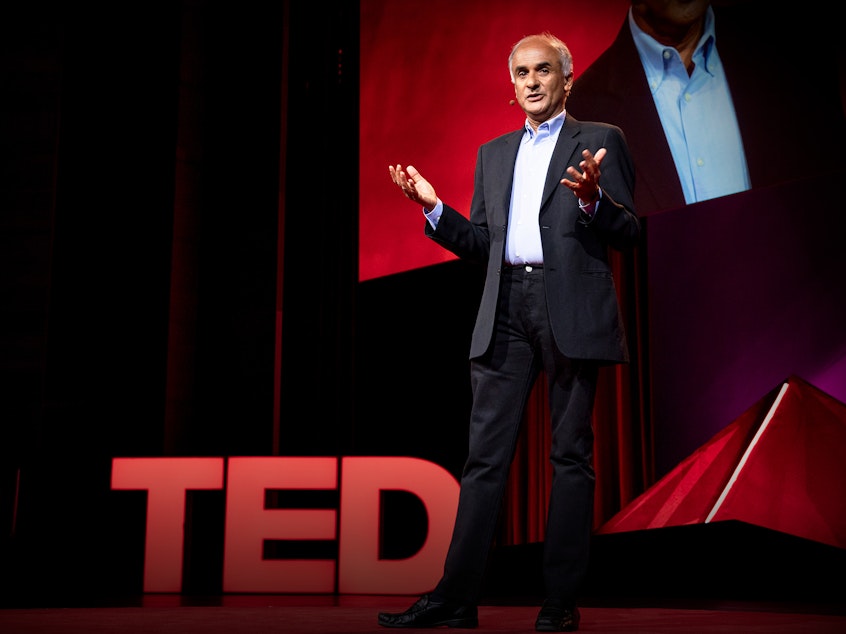 caption: Pico Iyer on the TED stage
