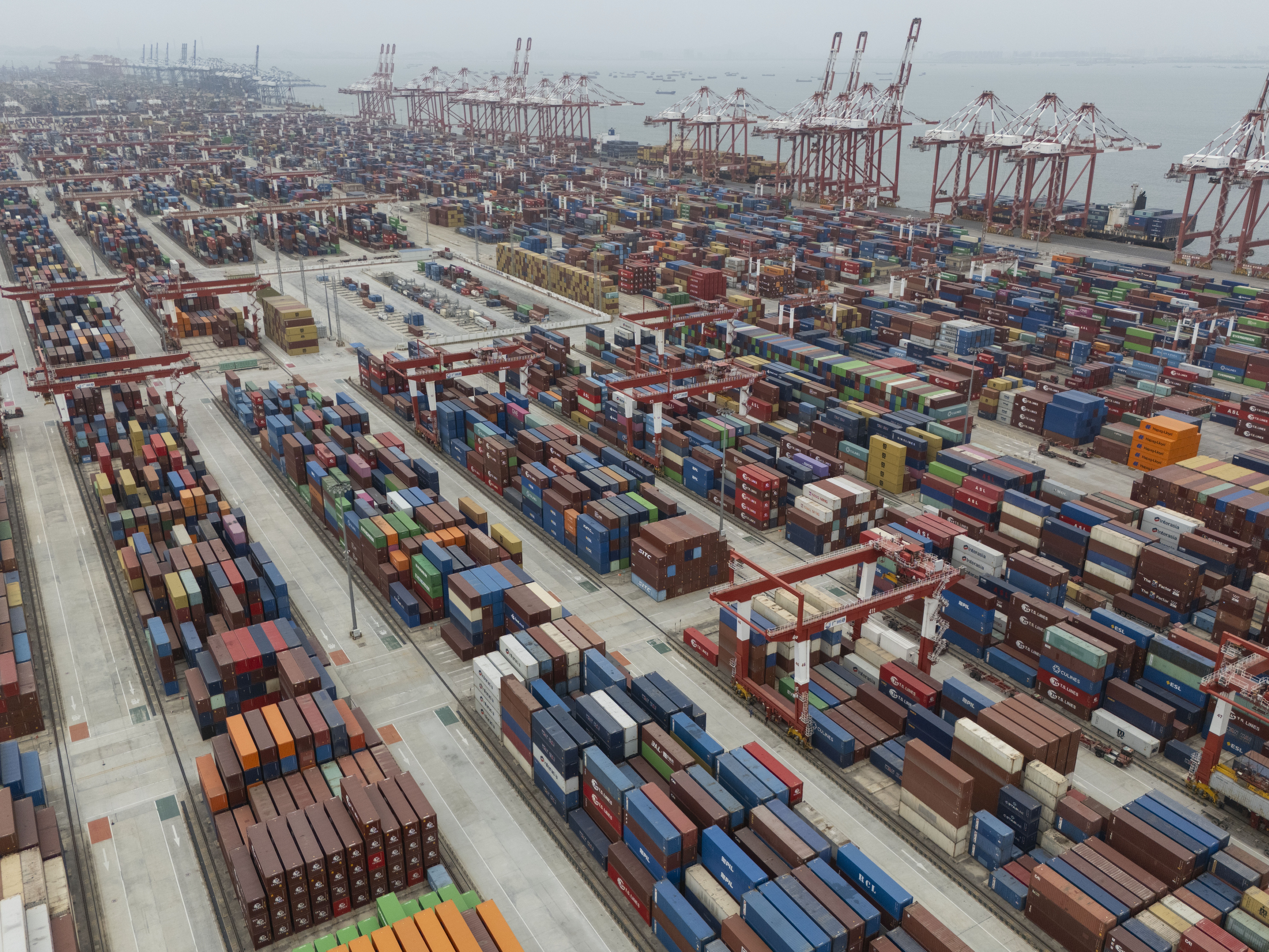 caption: Shipping containers are seen ready for transport at the Guangzhou Port in the Nansha district in southern China's Guangdong province in April 2025.
