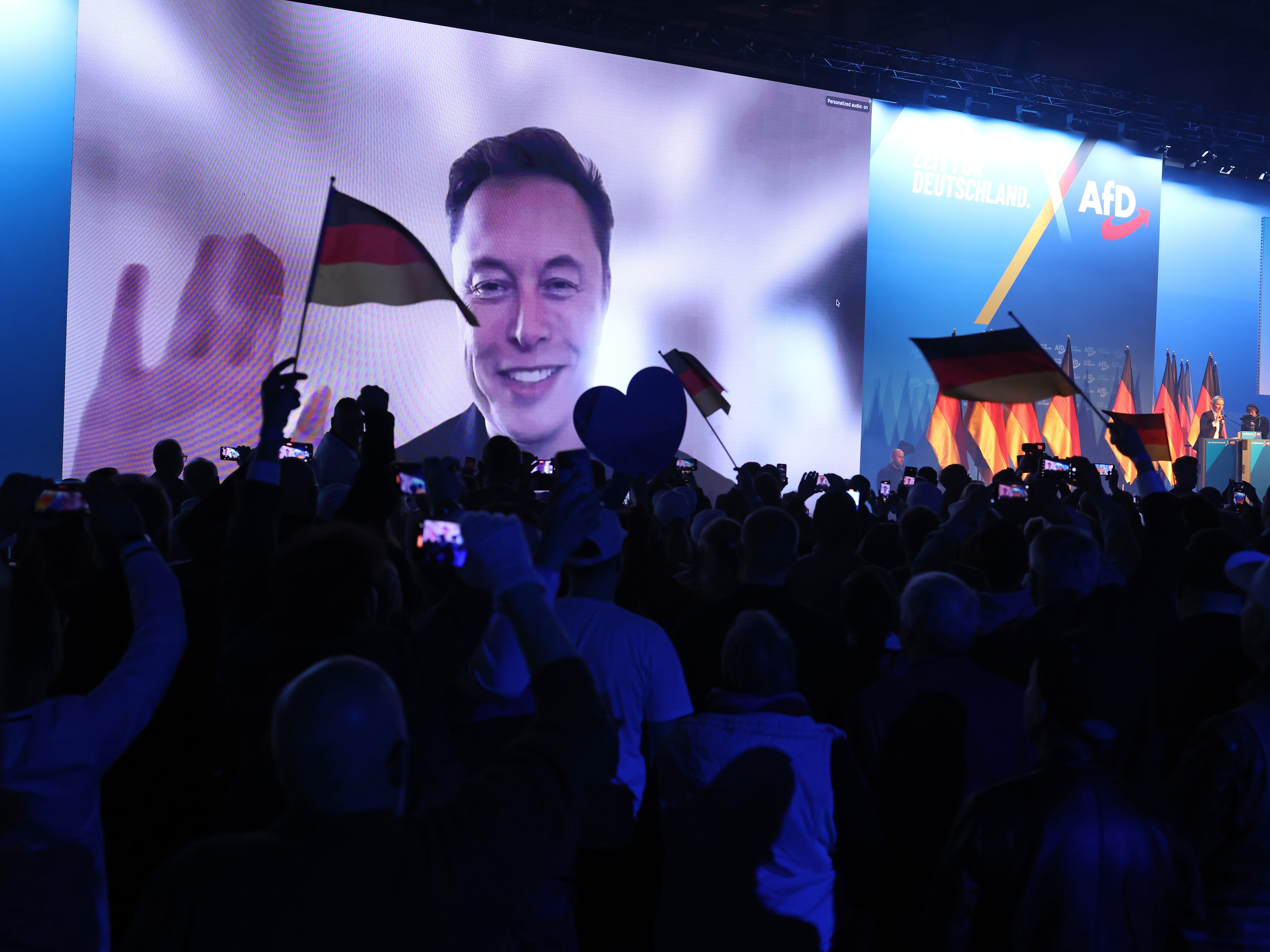caption: Elon Musk made a surprise virtual appearance at a campaign rally for the far-right Alternative for Germany (AfD) political party in Halle, Germany, on Saturday.
