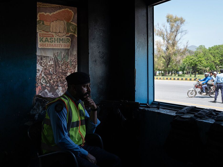 caption: A member of Pakistani security personnel looks over a checkpoint from a police booth amid heightened security ahead of a potential meeting between U.S. and Iranian officials in Islamabad, on Monday.