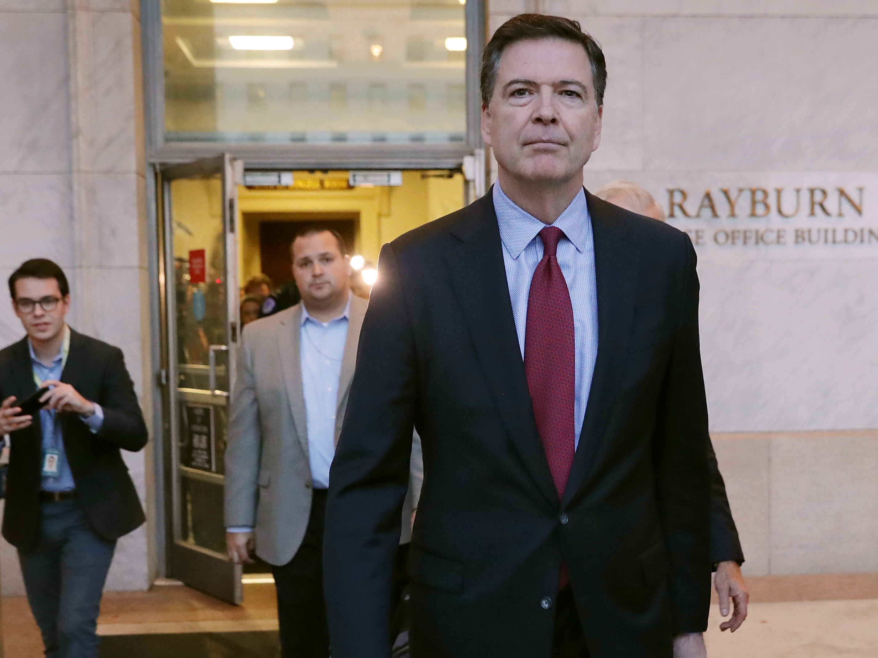 caption: Former Federal Bureau of Investigation Director James Comey leaves the Rayburn House Office Building after testifying on Capitol Hill Dec. 7, 2018, in Washington, D.C.