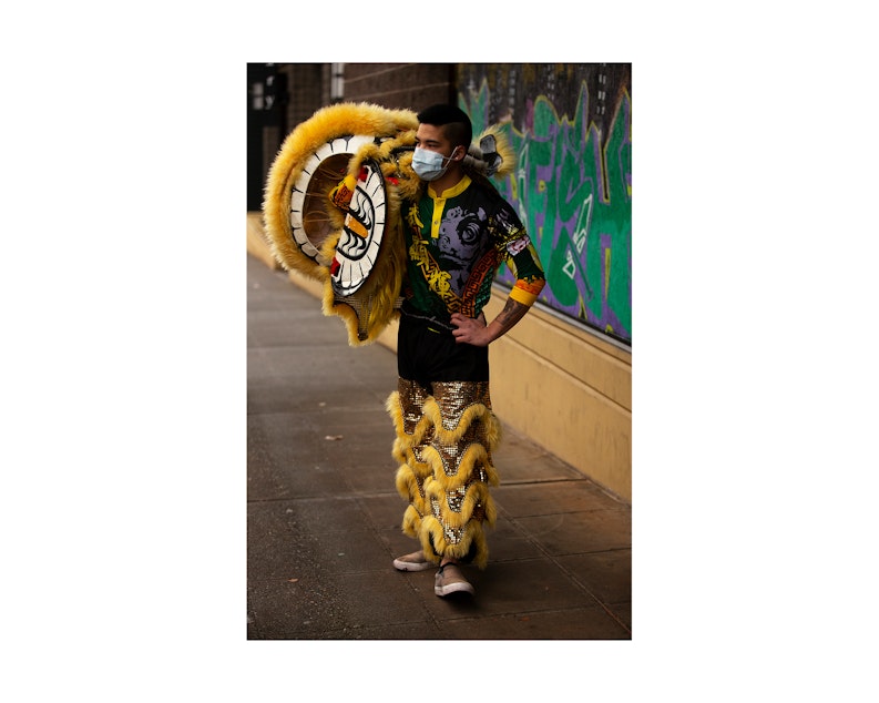 caption: Aaron Tu gets ready to perform with fellow Mak Fai Dragon and Lion dancers during the Lunar New Year celebration on Saturday, Feb. 4, 2023, in Seattle’s Chinatown-International District.