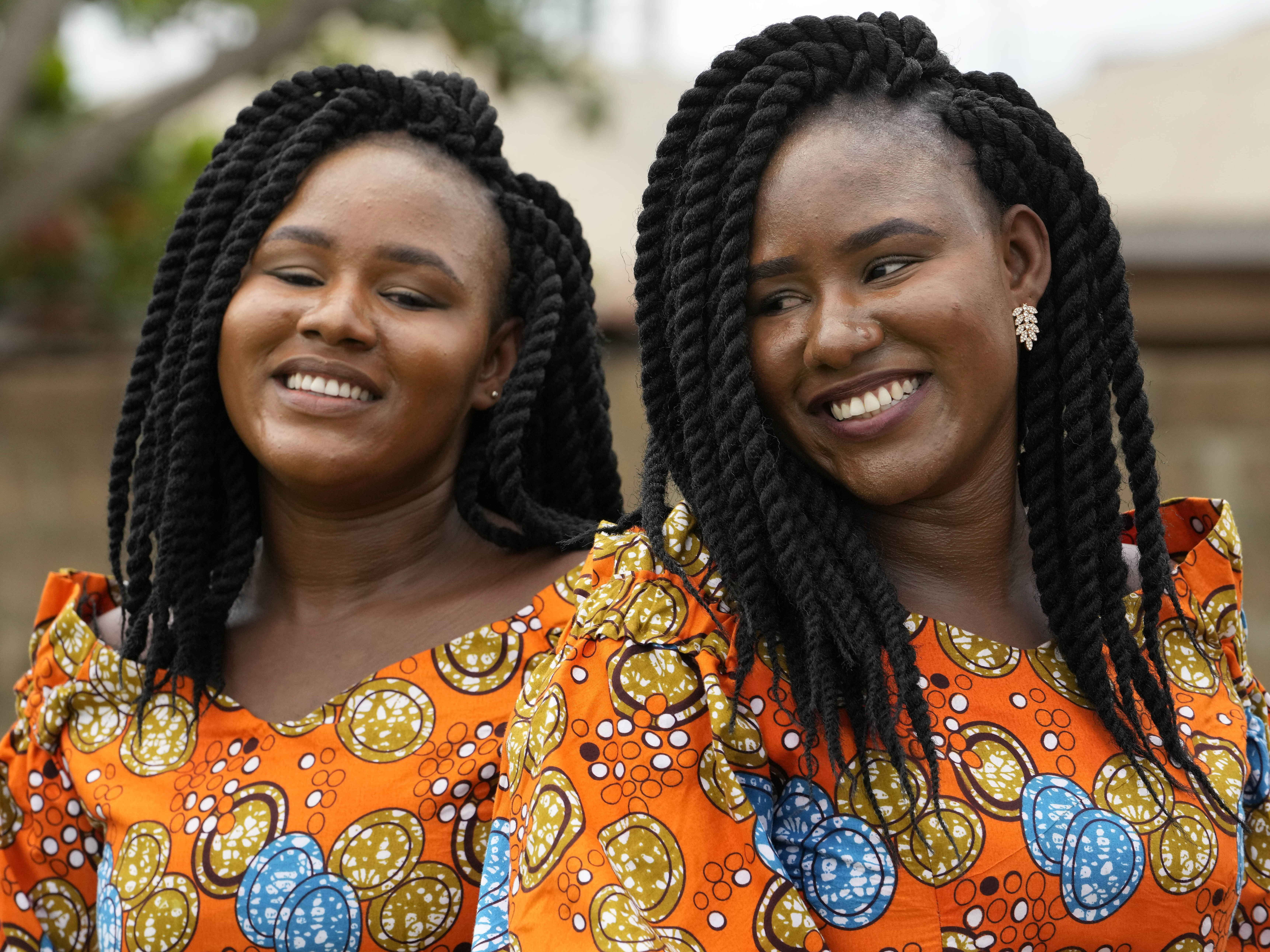 caption: Twins Kehinde Adamolekun, left, and Taiwo Adamolekun, 28, attend the annual twins festival in Igbo-Ora South west Nigeria, Saturday, Oct. 8, 2022.