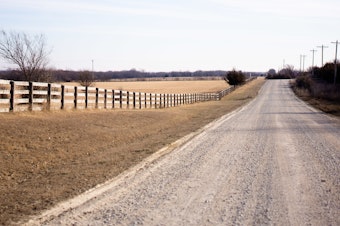 caption: The gravel road leading to Debbie and Bill Scroggins' house, outside Wichita, Kan.