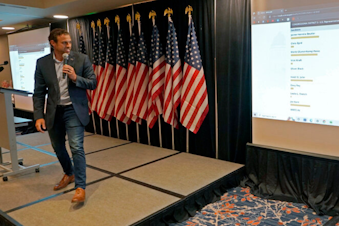 caption: Caleb Heimlich, chairman of the Washington State Republican Party, views early primary returns from the state's 3rd Congressional District race, Tuesday, Aug. 2, 2022, at a party event on Election Day in Issaquah, Wash., east of Seattle. In the race, Rep. Jaime Herrera Beutler, R-Wash., is facing eight challengers, four of whom are Republicans. 