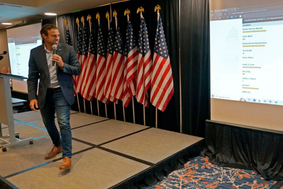 caption: Caleb Heimlich, chairman of the Washington State Republican Party, views early primary returns from the state's 3rd Congressional District race, Tuesday, Aug. 2, 2022, at a party event on Election Day in Issaquah, Wash., east of Seattle. In the race, Rep. Jaime Herrera Beutler, R-Wash., is facing eight challengers, four of whom are Republicans.