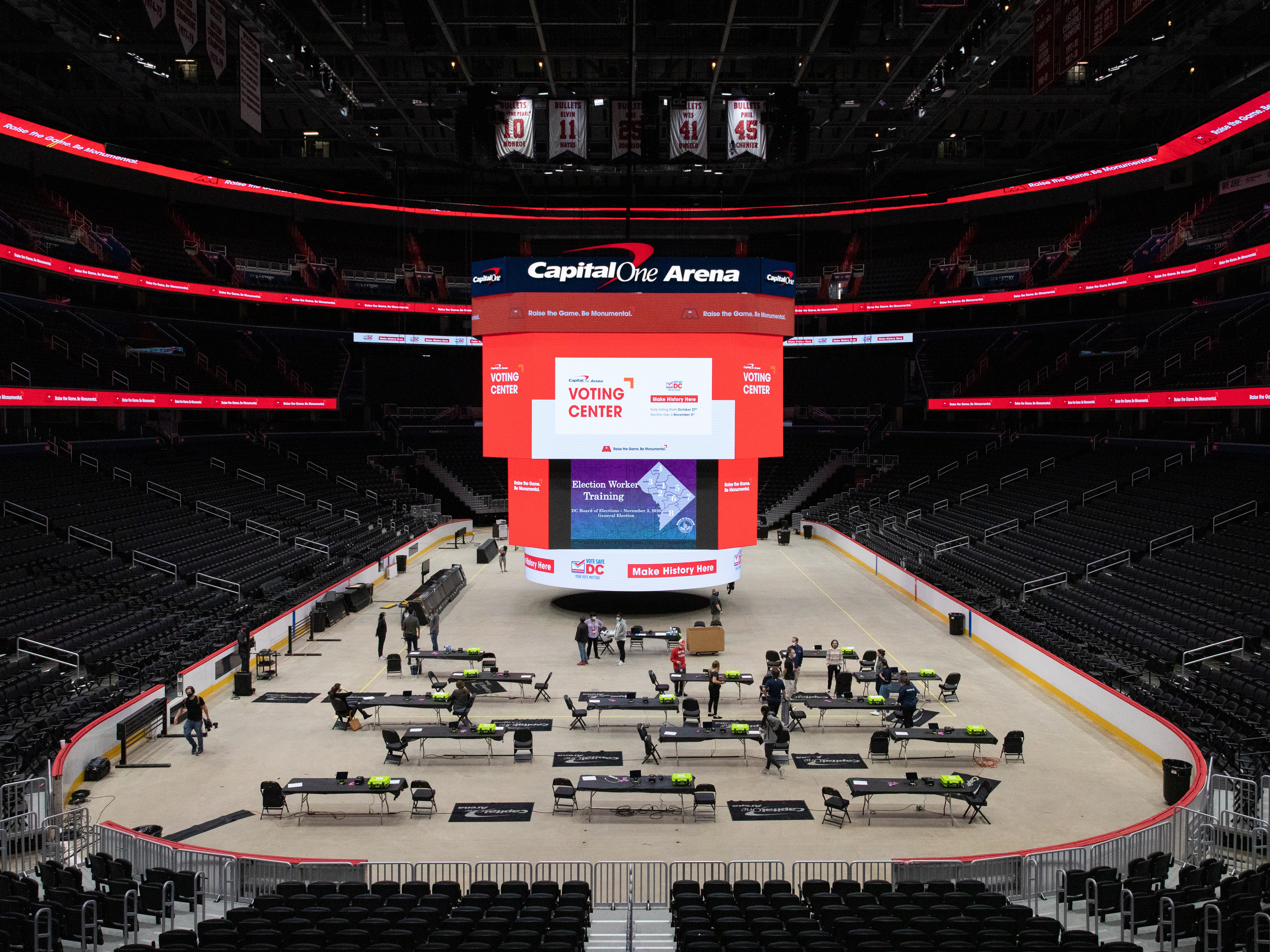caption: Voting trainers prepare to instruct poll workers in preparation for early voting at Capital One Arena in Washington, D.C., on Oct. 19.