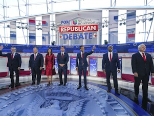 caption: Republican presidential candidates, from left, North Dakota Gov. Doug Burgum, former New Jersey Gov. Chris Christie, former U.N. Ambassador Nikki Haley, Florida Gov. Ron DeSantis, entrepreneur Vivek Ramaswamy, Sen. Tim Scott, R-S.C., and former Vice President Mike Pence, at a debate hosted by FOX Business and Univision, Wednesday at the Ronald Reagan Presidential Library in Simi Valley, Calif.
