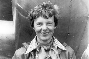 caption: File photo of Amelia Earhart beneath the nose of her Lockheed Model 10 Electra in Oakland, California, in March 1937.
