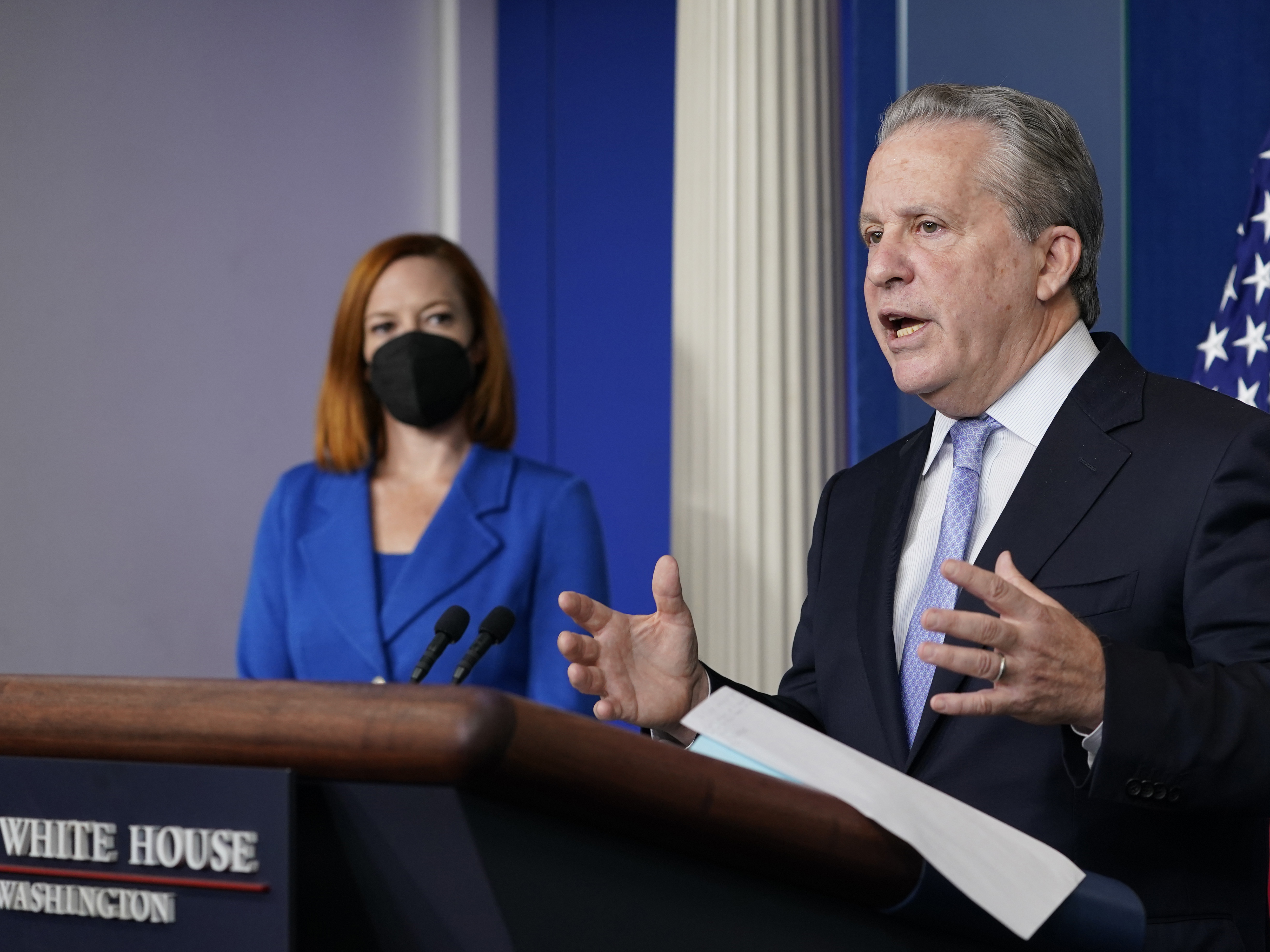 caption: Gene Sperling, who leads the oversight for distributing funds from President Biden's $1.9 trillion coronavirus rescue package, speaks during the daily White House press briefing Monday, as White House press secretary Jen Psaki looks on.