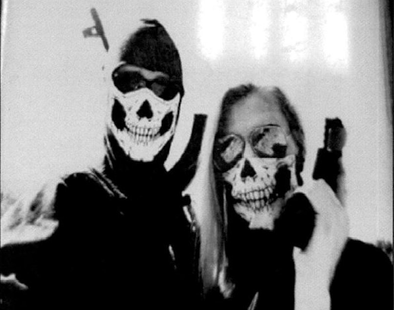 caption: Law enforcement officials say they obtained this image from Kaleb Cole's cell phone. Cole appears on the left. Police say he is a self-proclaimed member of a neo-Nazi group called Atomwaffen Division. 