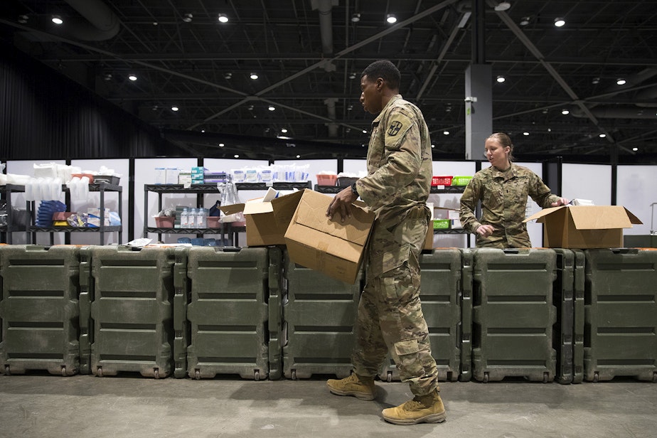 caption: U.S. Army soldiers store medical equipment near the ICU area of the military field hospital inside CenturyLink Field Event Center on Sunday, April 5, 2020, in Seattle. The 250-bed hospital for non COVID-19 patients was deployed by U.S. Army soldiers from the 627th Army Hospital from Fort Carson, Colorado, as well as soldiers from Joint Base Lewis-McChord. 