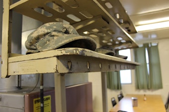 caption: FILE: Soldiers place their hats on rack just inside the mess hall doors before eating breakfast at Joint Base Lewis-McChord in January 2015.