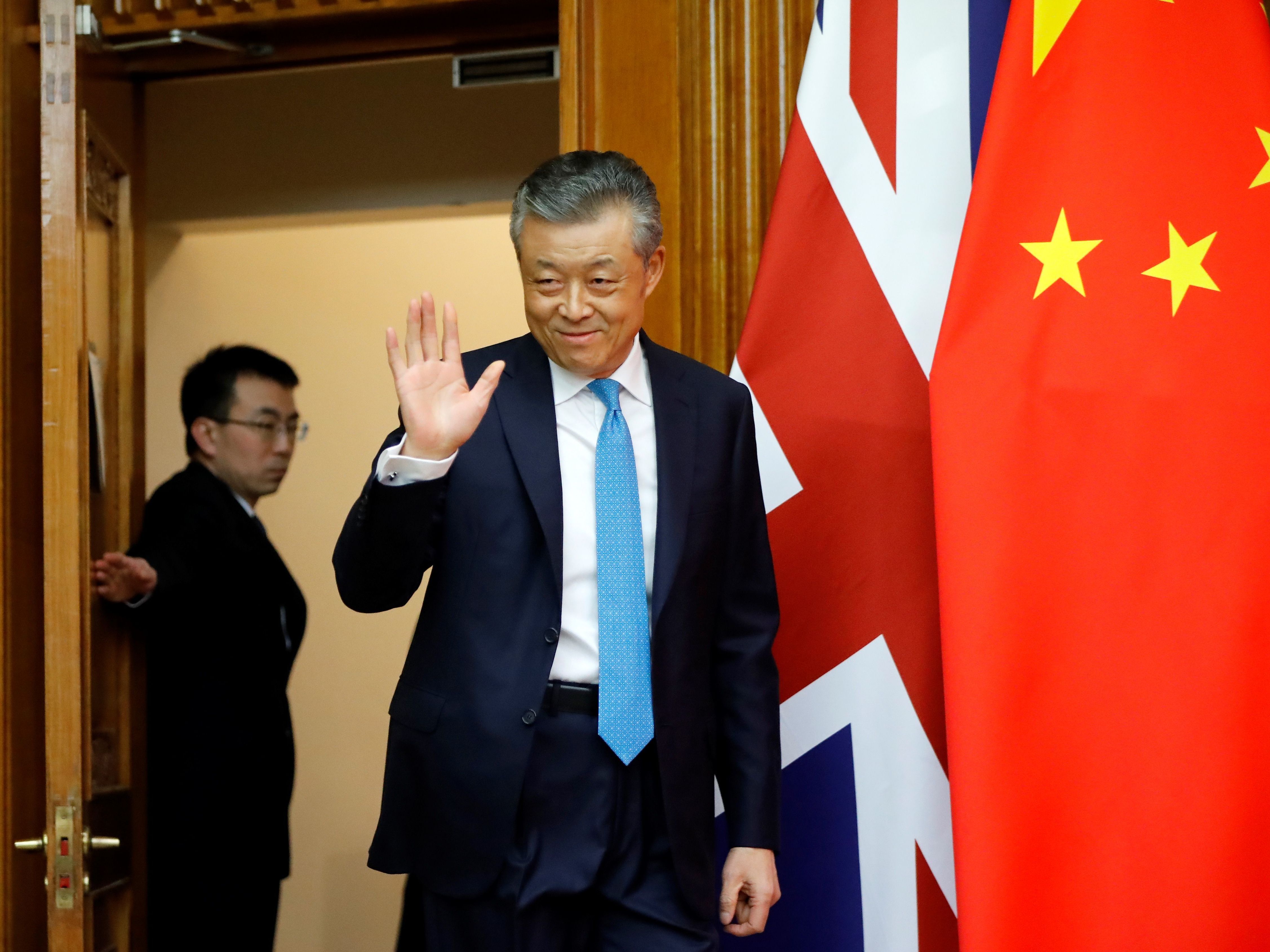 caption: China's ambassador to Britain Liu Xiaoming arrives at the Chinese Embassy in London in February for a press conference on the coronavirus outbreak in Wuhan.