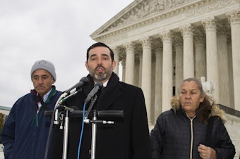 caption: Attorney Cristobal Galindo, center, is accompanied by Jesus Hernandez, left, and Maria Guereca, and attorney Marion Reilly in front of the Supreme Court, in Nov. 2019.