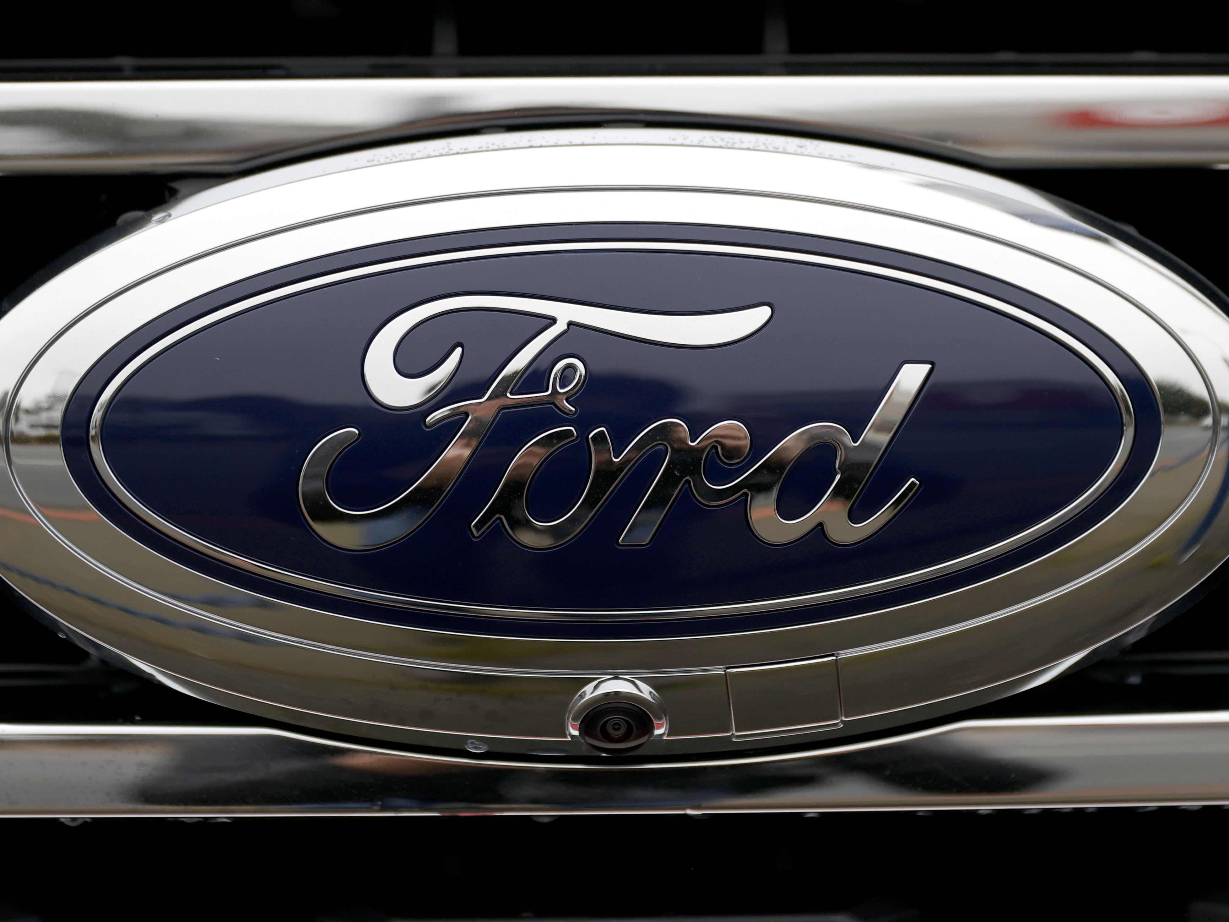 caption: The Ford Bronco logo is displayed on a vehicle in Colma, Calif., on Jan. 5. The American automaker is splitting its auto business into two units.