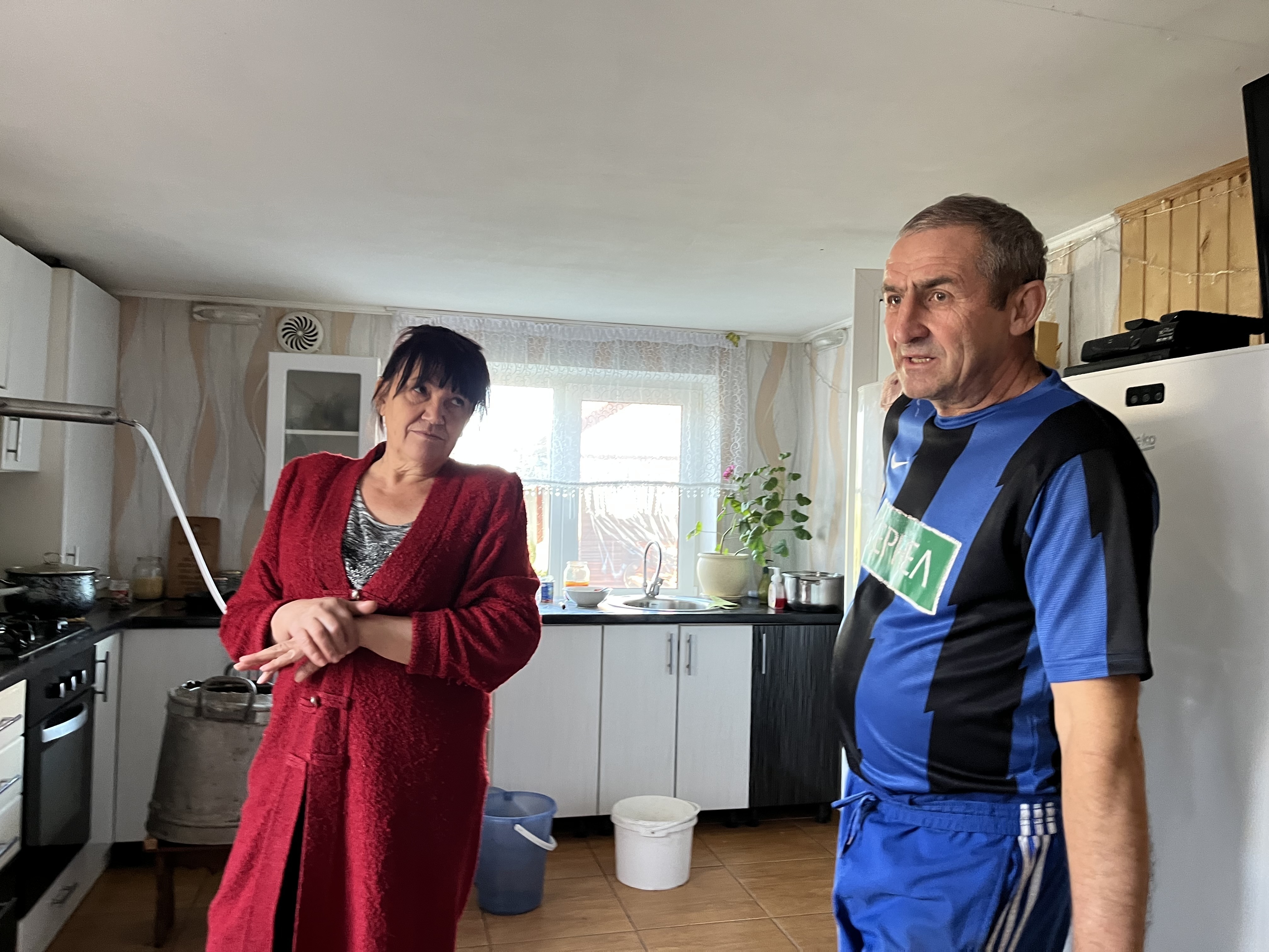 caption: Volodymyr and Svitlana Tsyba speak in their home in Hrushivka, Ukraine, on Oct. 18. They say they were detained by Ukrainian intelligence officials looking for Russian collaborators.