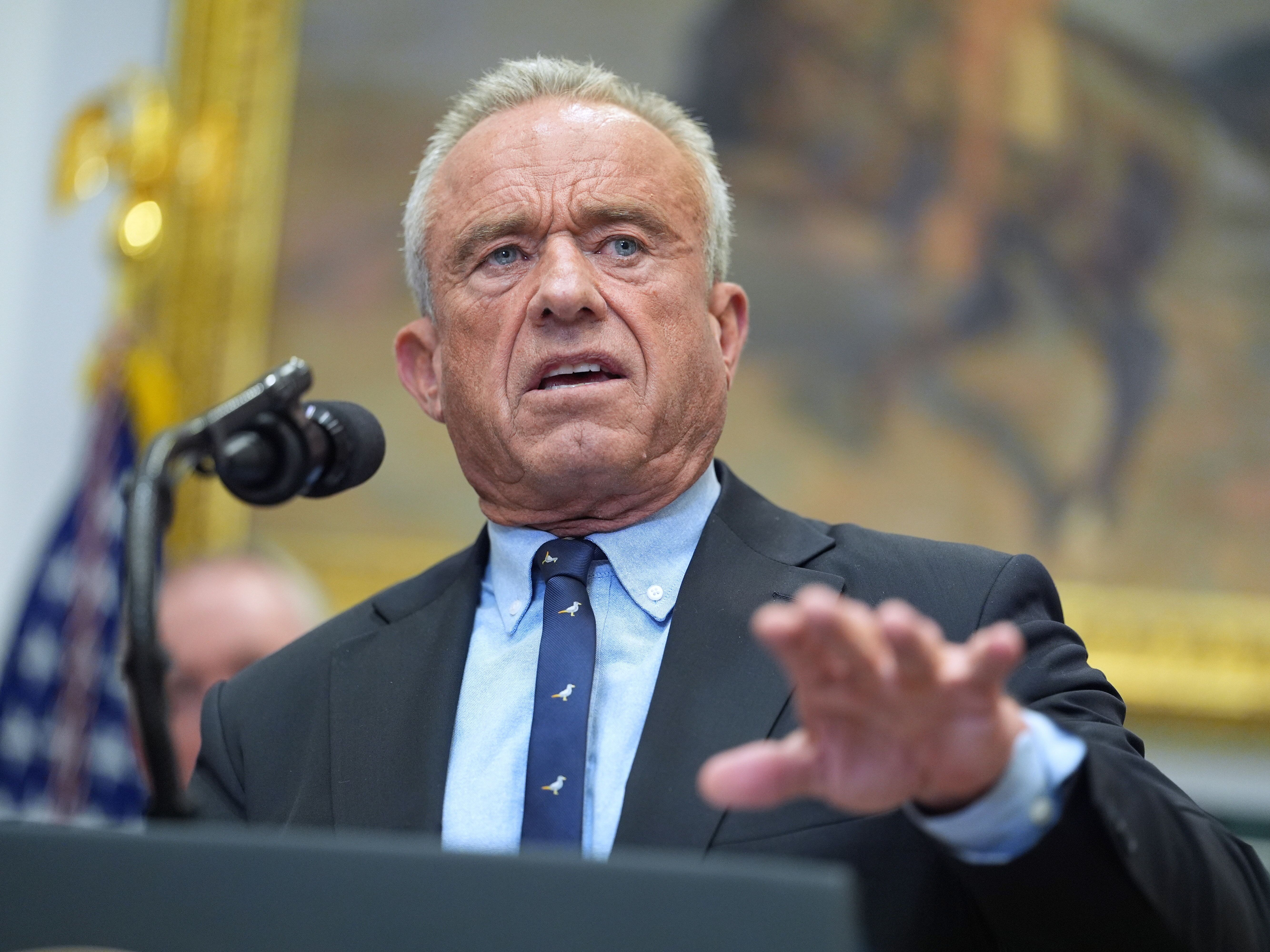 caption: Secretary of Health and Human Services, Robert F. Kennedy, Jr., speaks during an event on prescription drug prices in the Roosevelt Room of the White House, Friday, Dec. 19, 2025, in Washington.