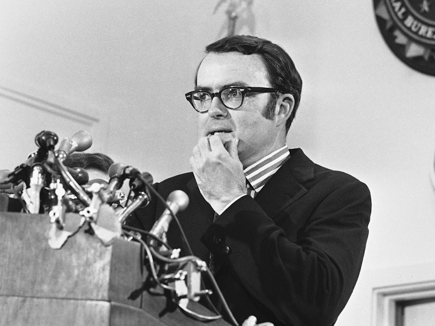 caption: Then-acting FBI Director William D. Ruckelshaus pauses during a May 1973 news conference in Washington, D.C. Ruckelshaus died Wednesday at the age of 87.