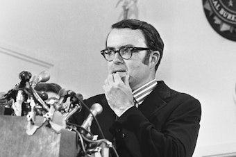 caption: Then-acting FBI Director William D. Ruckelshaus pauses during a May 1973 news conference in Washington, D.C. Ruckelshaus died Wednesday at the age of 87.