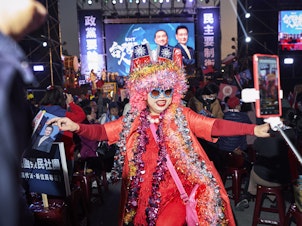caption: "Excited sister" — a fixture at Kuomintang rallies — makes her presence known at a rally for the KMT presidential candidate Hou Yu-ih on Jan. 6.