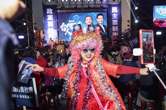 caption: "Excited sister" — a fixture at Kuomintang rallies — makes her presence known at a rally for the KMT presidential candidate Hou Yu-ih on Jan. 6.