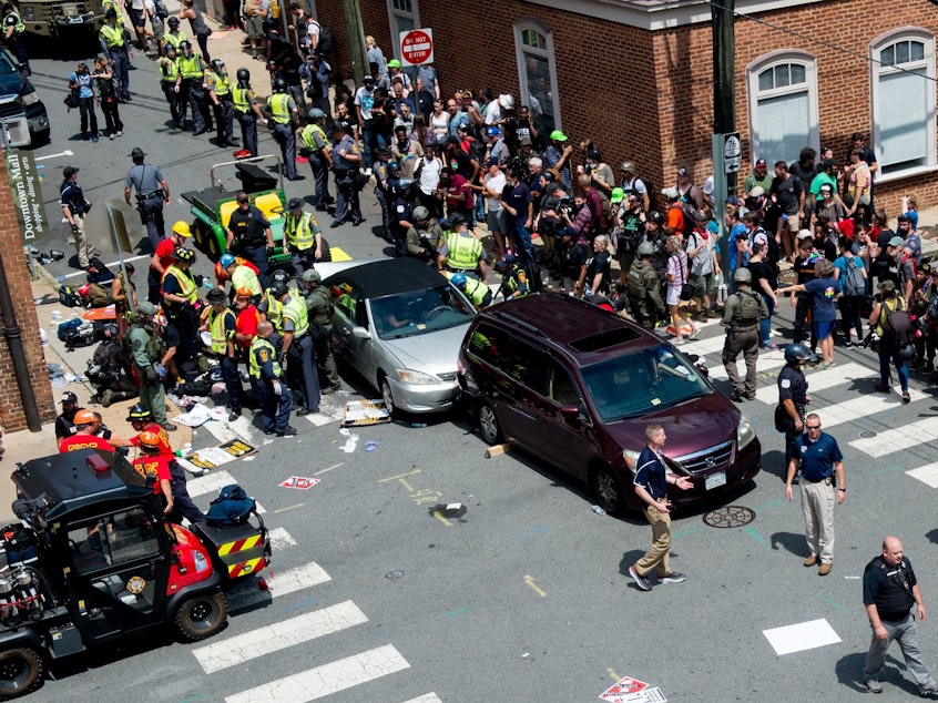 caption: People receive first-aid after a car ran into a crowd of protesters in Charlottesville, Va., on Aug. 12, 2017. Terrorism researchers say right-wing extremists are turning cars into weapons in response to the ongoing protests against police misconduct.