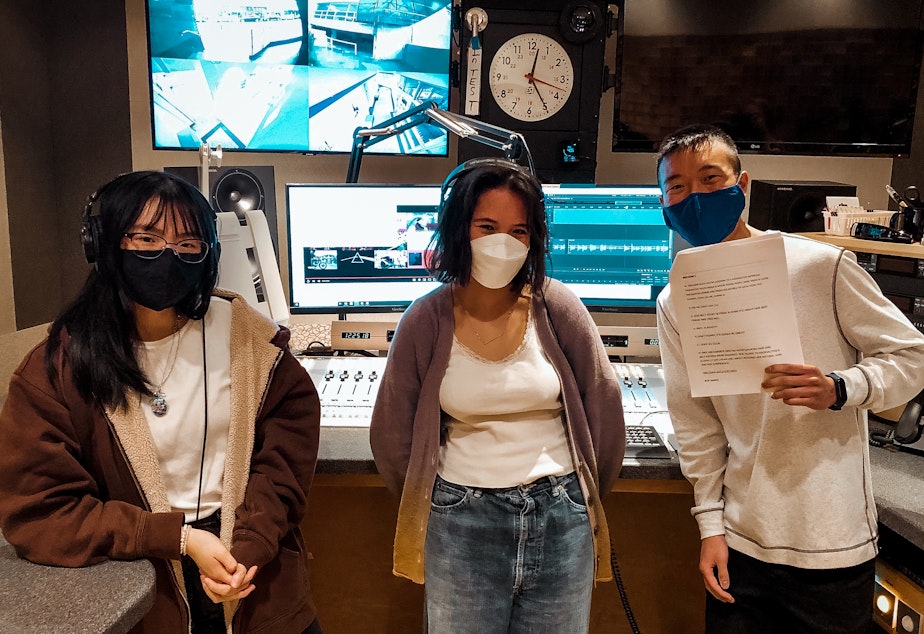 caption: Alayna Ly (left), Charlotte Engrav, and Colin Yuen pose in a KUOW studio on November 6, 2021. 