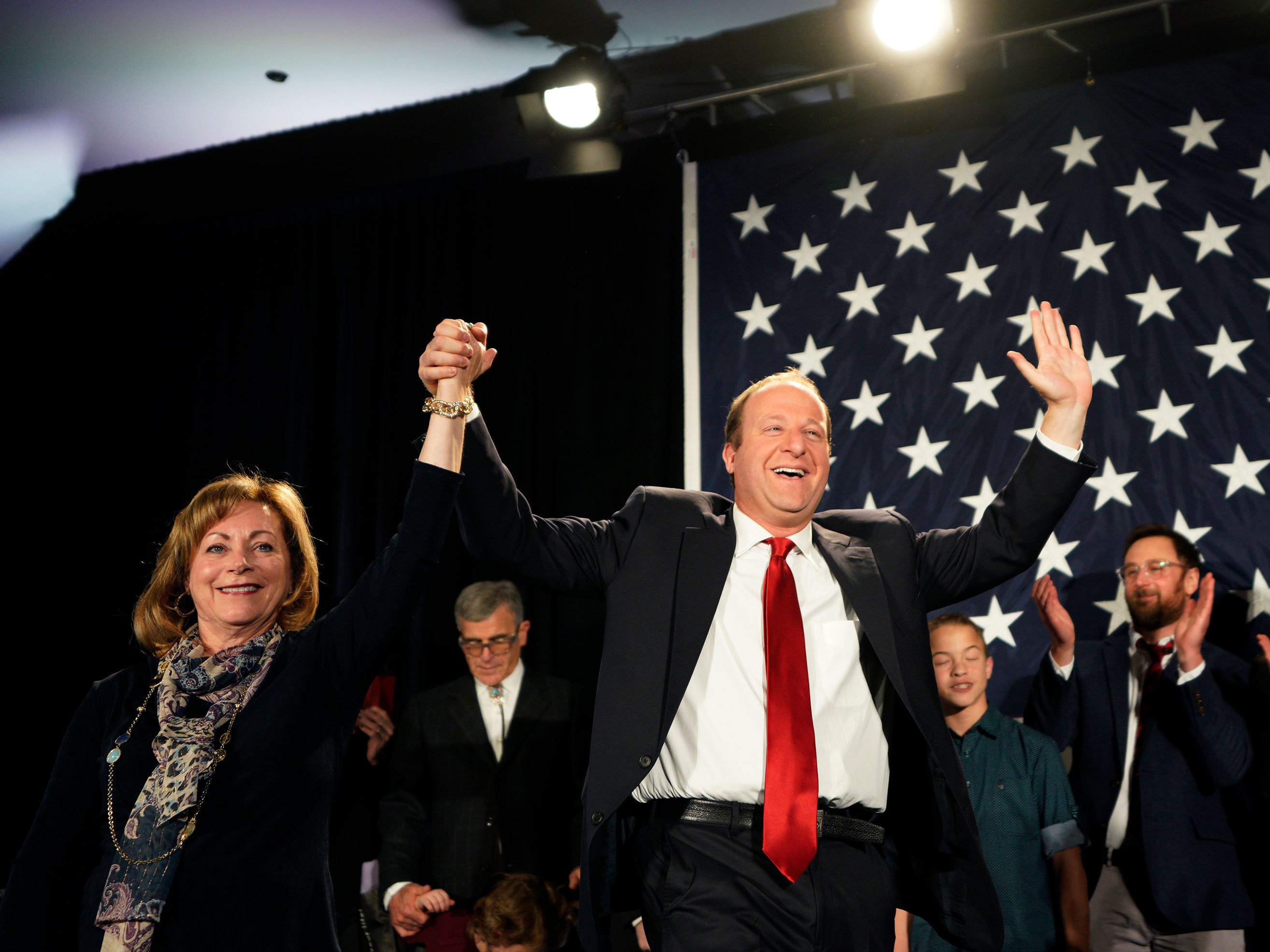 caption: Jared Polis arrives onstage with running mate Dianne Primavera in Colorado. Polis defeated incumbent Republican Gov. Walker Stapleton to become the first openly gay man elected governor in the U.S.