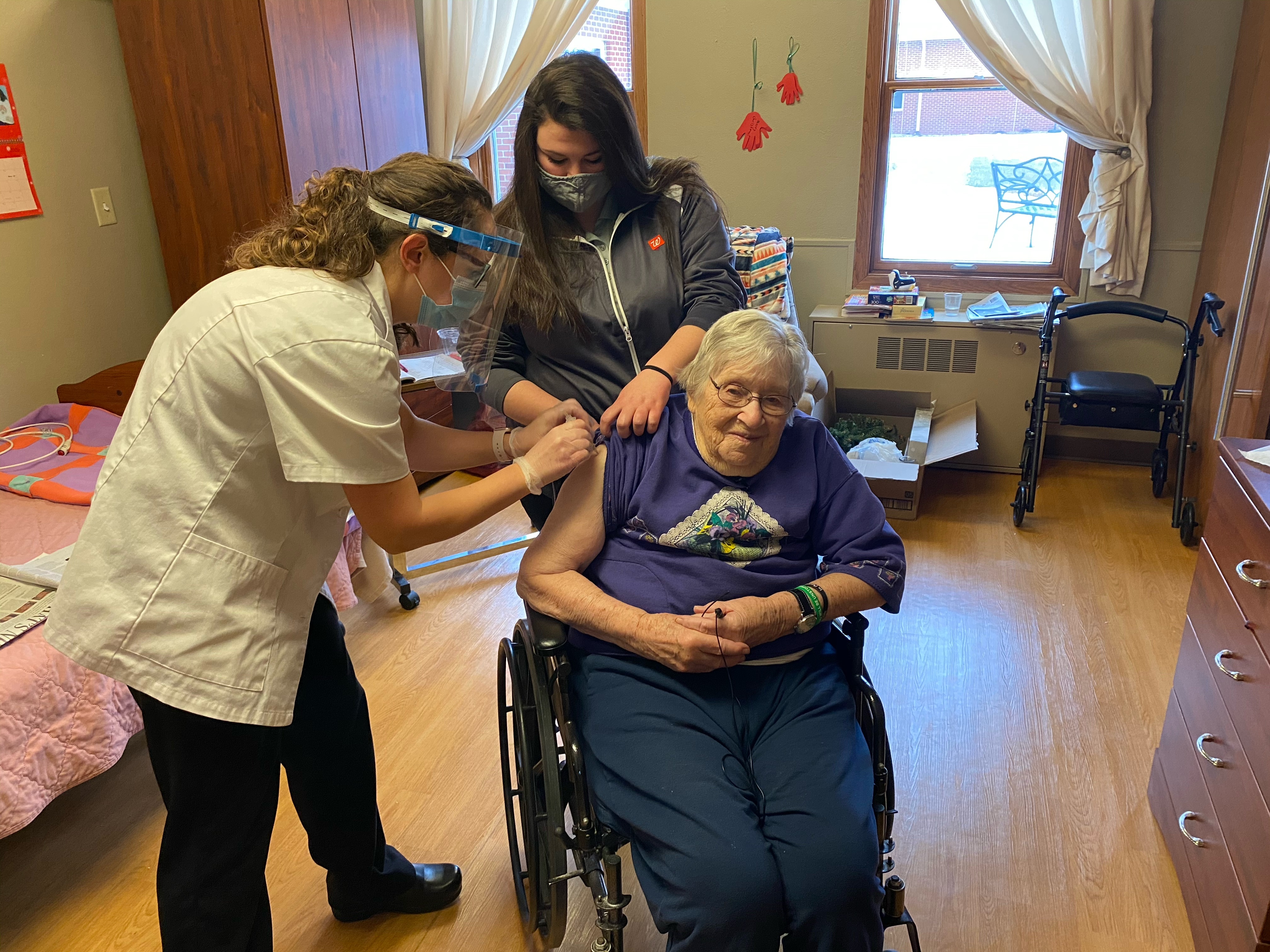 caption: Mary Ann Herbst, a patient at the Good Samaritan Society nursing home in Le Mars, Iowa, gets her first COVID-19 vaccine shot on Dec. 29, 2020. A recent study found only 4 out of 10 nursing home residents in the U.S. have gotten at least one dose of the most recent COVID vaccine, which was released last fall.<br>