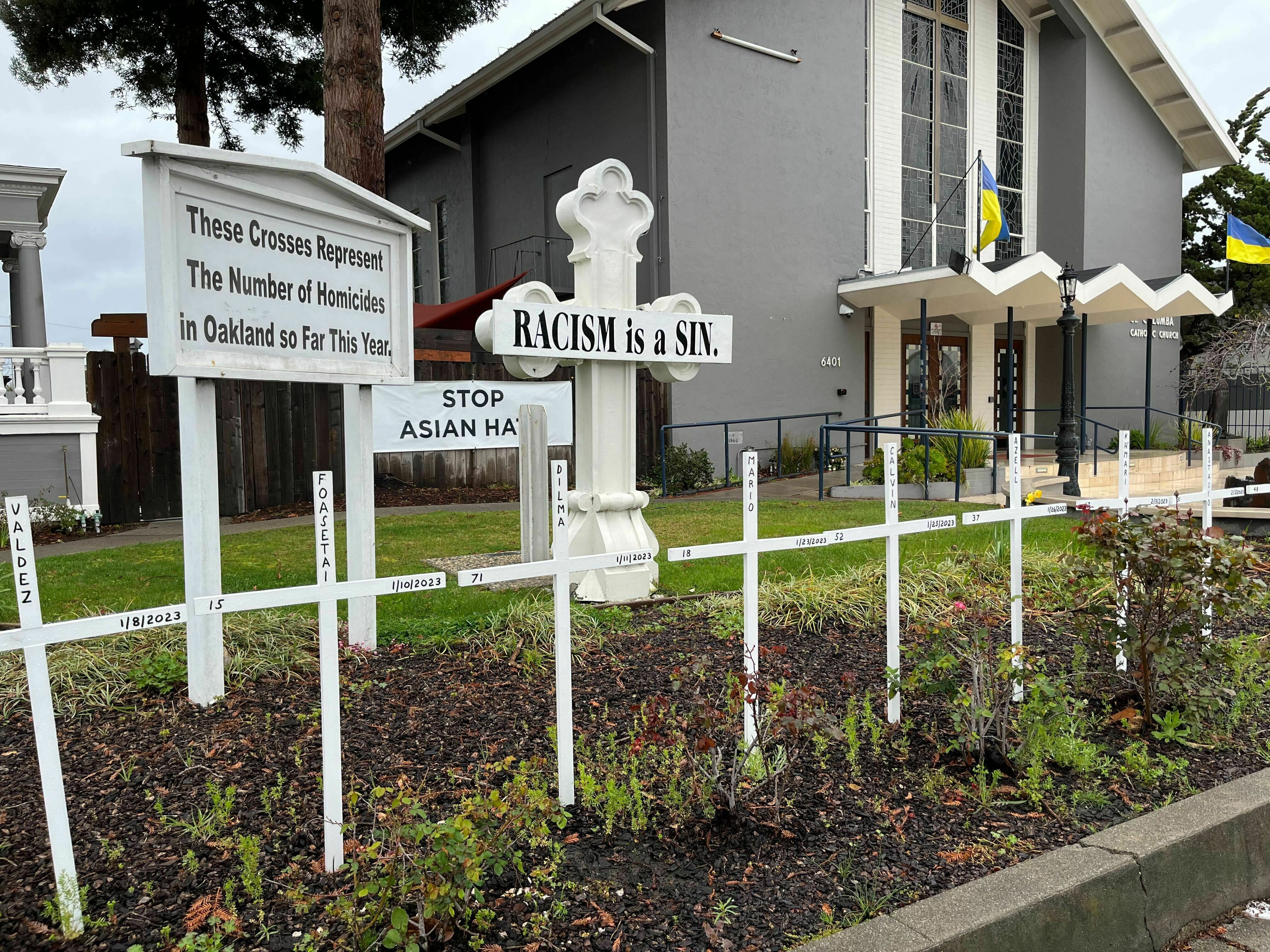 caption: Saint Columba Catholic Church in Oakland, Calif., commemorates every murder in the city with wooden crosses in its front garden. The city's homicide rate remains stubbornly high while its murder clearance rate remains well under the already low national average.