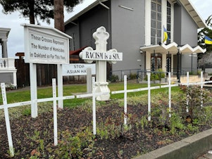 caption: Saint Columba Catholic Church in Oakland, Calif., commemorates every murder in the city with wooden crosses in its front garden. The city's homicide rate remains stubbornly high while its murder clearance rate remains well under the already low national average.