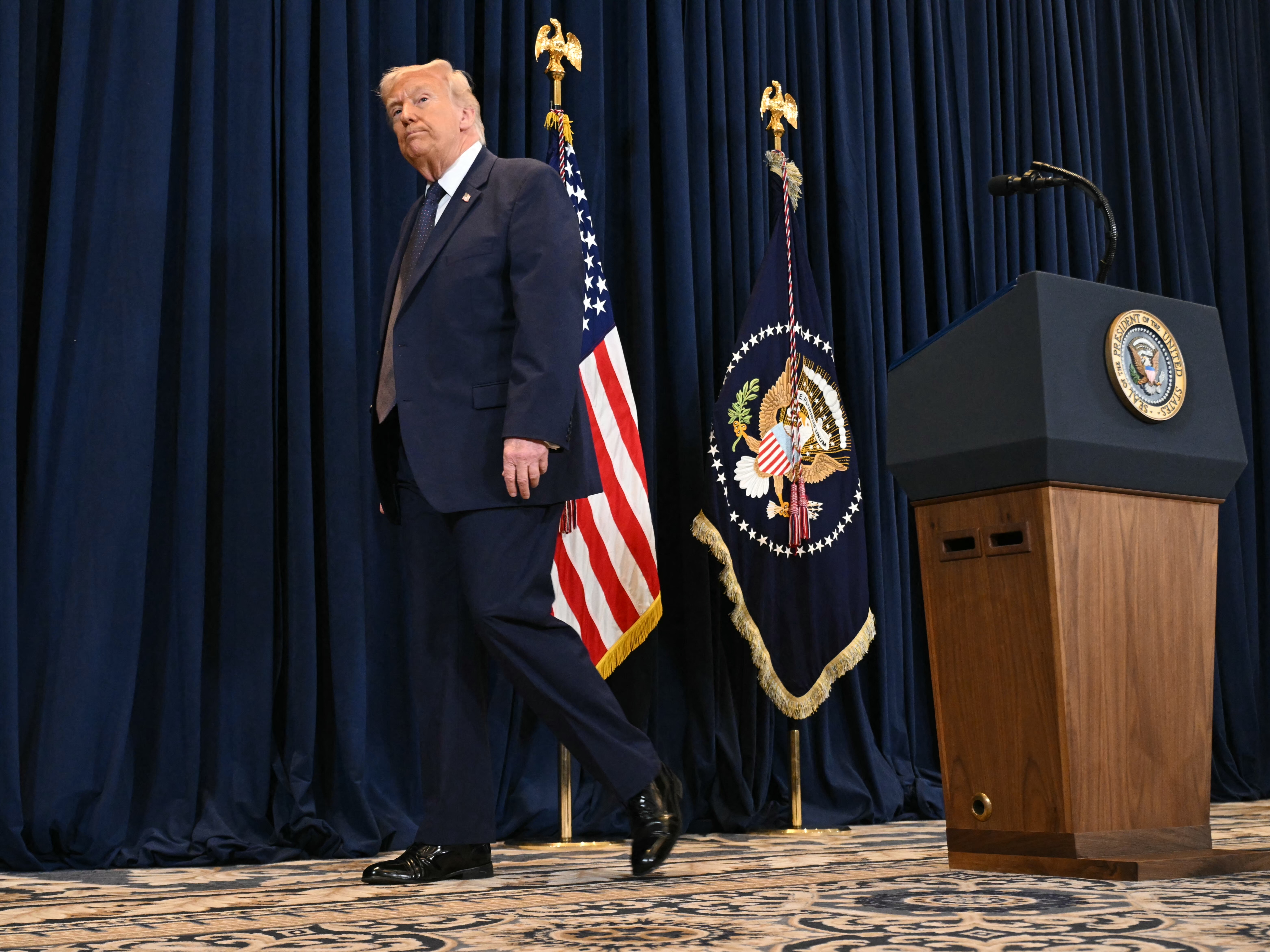 caption: President Trump leaves after a press conference in Miami on Monday. Many of the questions asked focused on the U.S.-Israeli war with Iran.